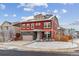 Charming two-story home with red siding, stone accents, and a well-maintained front yard in winter at 23593 E Chenango Pl, Aurora, CO 80016
