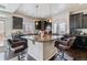Modern kitchen with a granite island, dark cabinetry, pendant lighting, and stainless steel appliances at 23593 E Chenango Pl, Aurora, CO 80016
