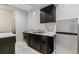 Kitchenette equipped with a sink, cabinets, countertop, and a mini-fridge at 23593 E Chenango Pl, Aurora, CO 80016