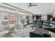 Spacious living area with modern furniture, large windows, and an open layout leading to the kitchen at 23593 E Chenango Pl, Aurora, CO 80016