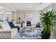 Modern living room with comfortable seating, a contemporary rug, and ample natural light at 23593 E Chenango Pl, Aurora, CO 80016