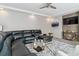 Stylish living room featuring a comfortable sectional, a modern glass table, and decorative accents at 23593 E Chenango Pl, Aurora, CO 80016