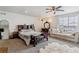 Spacious main bedroom with a sofa, a vanity, a walk-in closet, and lots of natural light at 23593 E Chenango Pl, Aurora, CO 80016