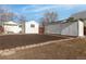 Spacious backyard with a white house, a storage shed, and mulch with stone edging at 1130 Orchard St, Golden, CO 80401