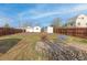 Large backyard with a patio, furniture, a wooden fence, and a house painted in bright white at 1130 Orchard St, Golden, CO 80401