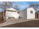 Cozy backyard featuring a small patio area and well-maintained landscaping with the house painted in bright white at 1130 Orchard St, Golden, CO 80401
