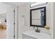 Bathroom featuring updated vanity, large black framed mirror, and modern lighting fixtures at 1130 Orchard St, Golden, CO 80401