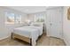 Well-lit bedroom with a minimalist design, featuring a large bed, wood floors and two windows at 1130 Orchard St, Golden, CO 80401