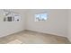 Clean bedroom with wood floors, two windows and light-colored walls at 1130 Orchard St, Golden, CO 80401