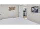 Bright bedroom featuring a doorway view to the kitchen, a queen bed and unique wall decor at 1130 Orchard St, Golden, CO 80401