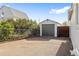 A detached garage with a gray door is conveniently located in the backyard with a driveway leading up to it at 1130 Orchard St, Golden, CO 80401