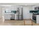 Charming kitchen featuring stainless steel appliances, wood-look flooring, and sleek white cabinetry at 1130 Orchard St, Golden, CO 80401