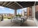Inviting covered patio featuring a dining set with views of the neighborhood at 10113 Bellwether Ln, Lone Tree, CO 80124