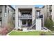 Backyard with patio, outdoor seating, green grass and landscaping including a stairway to balcony at 10113 Bellwether Ln, Lone Tree, CO 80124