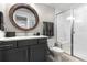 Stylish bathroom featuring a modern vanity, round mirror, and a glass-enclosed shower at 10113 Bellwether Ln, Lone Tree, CO 80124