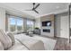 This bedroom includes a fireplace with a TV, large windows and a view of the outdoors at 10113 Bellwether Ln, Lone Tree, CO 80124