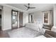 This spacious bedroom boasts natural light, a ceiling fan and a sliding barn door for the ensuite bathroom at 10113 Bellwether Ln, Lone Tree, CO 80124