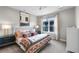 Cozy bedroom with decorative patterned bedding and light, natural lighting at 10113 Bellwether Ln, Lone Tree, CO 80124