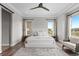 This bedroom features two large windows, lounge seating and a ceiling fan at 10113 Bellwether Ln, Lone Tree, CO 80124
