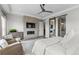 This bedroom features a fireplace with a TV, lounge seating and an ensuite bathroom at 10113 Bellwether Ln, Lone Tree, CO 80124