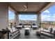Covered patio boasts lounge furniture, recessed lighting, ceiling fan, and neighborhood views at 10113 Bellwether Ln, Lone Tree, CO 80124