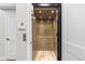 A residential elevator featuring paneled wood walls and flooring, overhead lights and black trim at 10113 Bellwether Ln, Lone Tree, CO 80124
