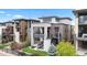 Modern three-story home with outdoor balconies, manicured lawn, and professional landscaping at 10113 Bellwether Ln, Lone Tree, CO 80124