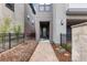 Paver walkway leading to front door with neutral exterior paint, black metal fence and xeriscaping at 10113 Bellwether Ln, Lone Tree, CO 80124