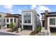 Contemporary style home showcasing a three-story facade with a gray two-car garage at 10113 Bellwether Ln, Lone Tree, CO 80124
