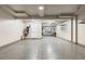 Spacious garage featuring epoxy flooring, storage cabinets, and ample room for vehicles at 10113 Bellwether Ln, Lone Tree, CO 80124