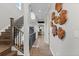 Bright hallway with hardwood floors, staircase, and unique wall art at 10113 Bellwether Ln, Lone Tree, CO 80124