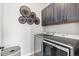 Modern laundry room with dark cabinets and decor, plus updated appliances at 10113 Bellwether Ln, Lone Tree, CO 80124