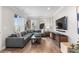 Cozy living room featuring a sectional sofa, hardwood floors, and large windows at 10113 Bellwether Ln, Lone Tree, CO 80124