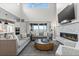 Bright living room with high ceilings, fireplace, large windows, and neutral furniture for a modern look at 10113 Bellwether Ln, Lone Tree, CO 80124