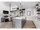 Open-concept living and dining area with a kitchen island, fireplace, and modern furnishings at 10113 Bellwether Ln, Lone Tree, CO 80124
