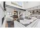 Open-concept living and dining area with a fireplace, modern furnishings, and plenty of natural light at 10113 Bellwether Ln, Lone Tree, CO 80124