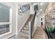 Bright staircase featuring wood stairs, modern iron railing, and a gallery wall of framed photos at 10113 Bellwether Ln, Lone Tree, CO 80124