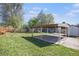 Large backyard featuring a covered carport and storage shed at 1151 Xanthia St, Denver, CO 80220