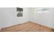 Cozy bedroom with refinished hardwood floors, a large window, and fresh white paint at 1151 Xanthia St, Denver, CO 80220