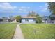 Cozy single-story home with a lush front yard and a white picket fence at 1151 Xanthia St, Denver, CO 80220