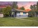 Charming single-story home with gray exterior, lush lawn, and a cozy front porch perfect for relaxing at 1151 Xanthia St, Denver, CO 80220