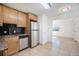 Well-lit kitchen with stainless steel appliances, granite counters, and tile flooring at 1151 Xanthia St, Denver, CO 80220