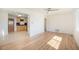 Open-concept living space with gleaming hardwood floors leading to a kitchen area at 1151 Xanthia St, Denver, CO 80220