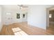 Spacious and well-lit living area with beautiful hardwood floors and access to the bathroom at 1151 Xanthia St, Denver, CO 80220