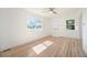 Bright, freshly painted living room featuring gleaming hardwood floors and modern ceiling fan at 1151 Xanthia St, Denver, CO 80220