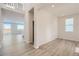 Bright living room with light wood floors, natural light, and open staircase to the upper level at 1291 Loraine N Cir, Lafayette, CO 80026