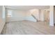 Bright living room with modern flooring and an adjacent staircase for easy access to upper floors at 1291 Loraine N Cir, Lafayette, CO 80026