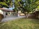 Spacious backyard with a concrete patio, mature tree, plenty of grass, and privacy fence. Perfect for outdoor entertaining at 12375 Ivy Pl, Brighton, CO 80602