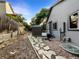 Fenced backyard featuring stone pathway, storage shed, and lush greenery at 12375 Ivy Pl, Brighton, CO 80602