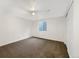 Bright bedroom featuring neutral carpet, white walls, and a window with natural light at 12375 Ivy Pl, Brighton, CO 80602